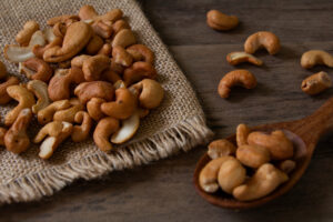 cashew,nuts,on,burlap,fabric,close,up,shot,on,wooden